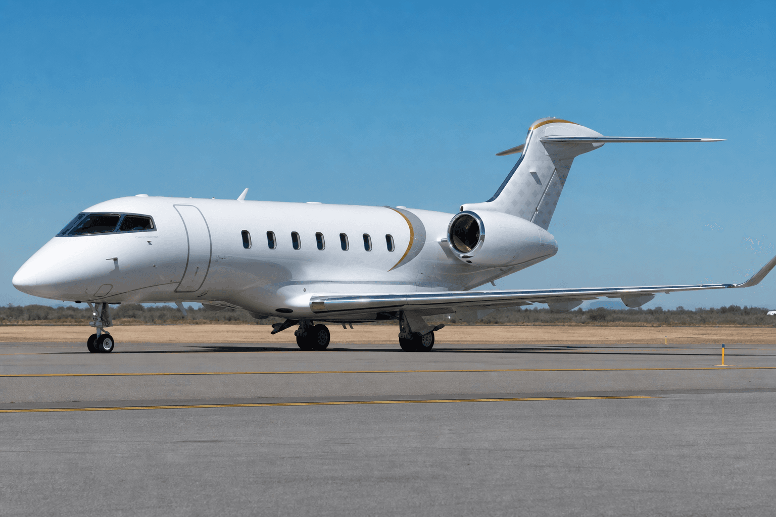 Bombardier Challenger 3500 business jet on taxiway with clear sky background