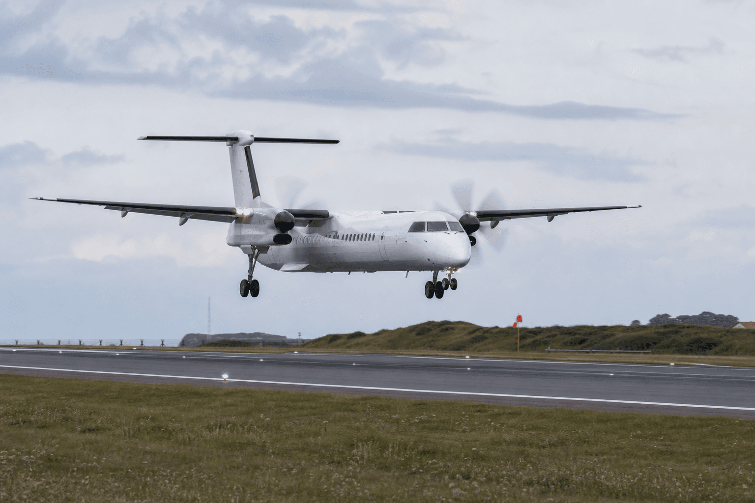 Dash 8-400 Lands Long and Overruns Runway at Guernsey Due to Touchdown Misjudgment