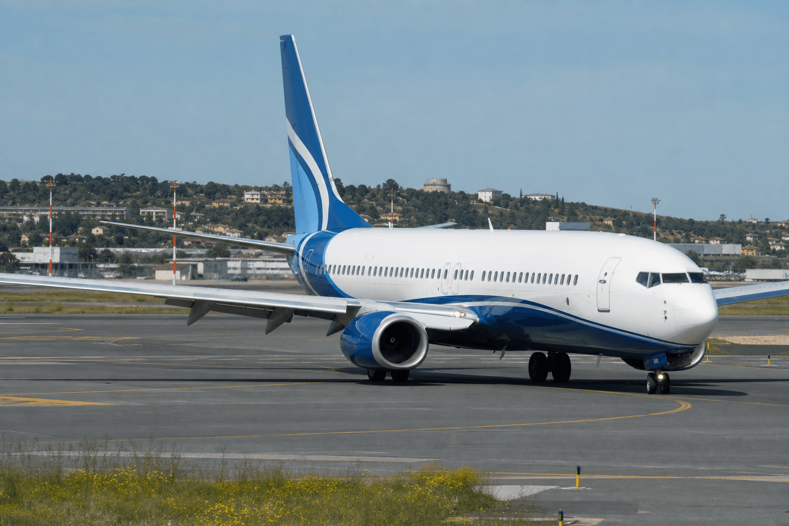Boeing 737-800 taxiing on runway at Thessaloniki Airport under cloudy sky