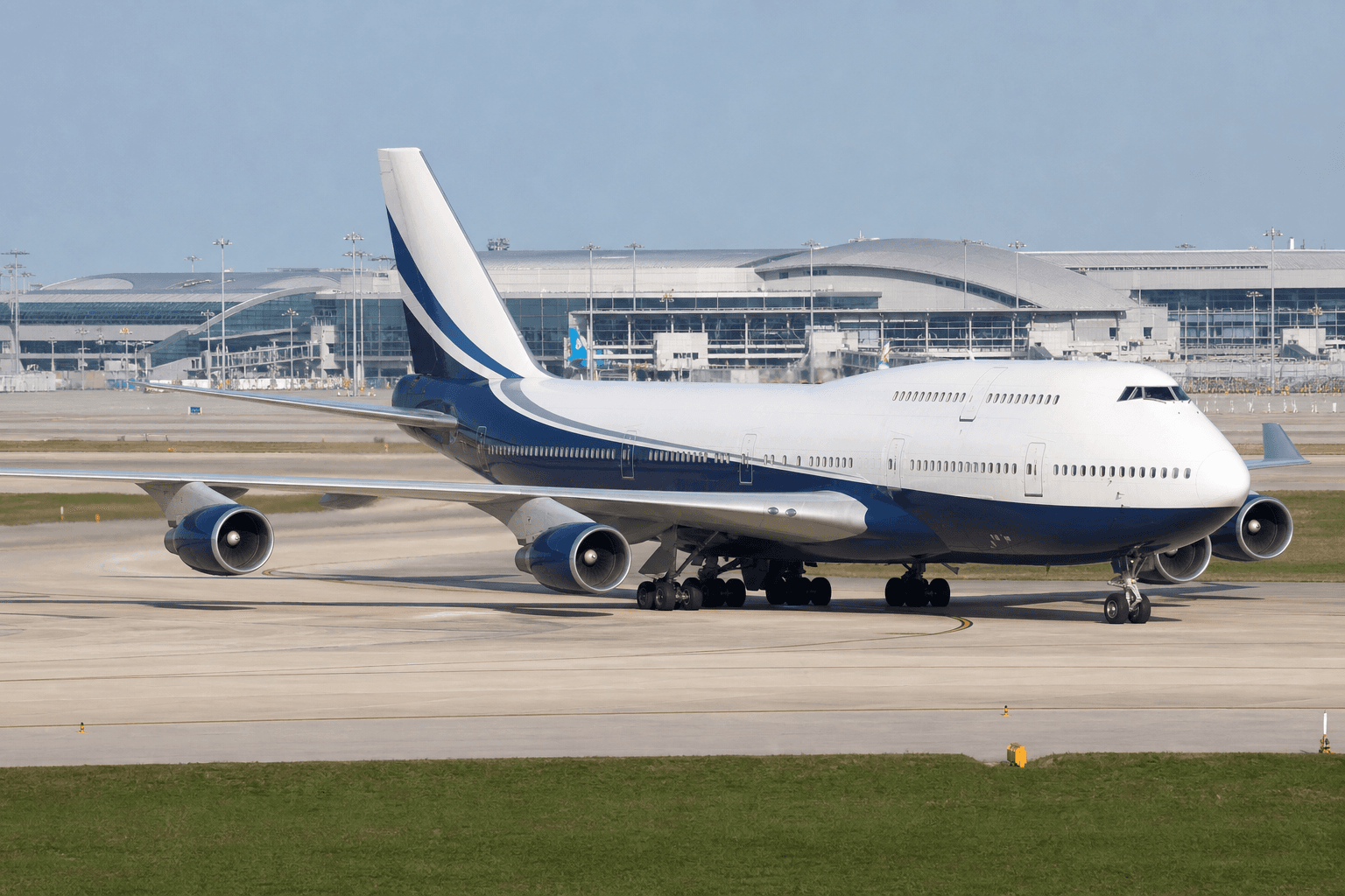 Boeing 747 aircraft parked at airport gate under clear daylight