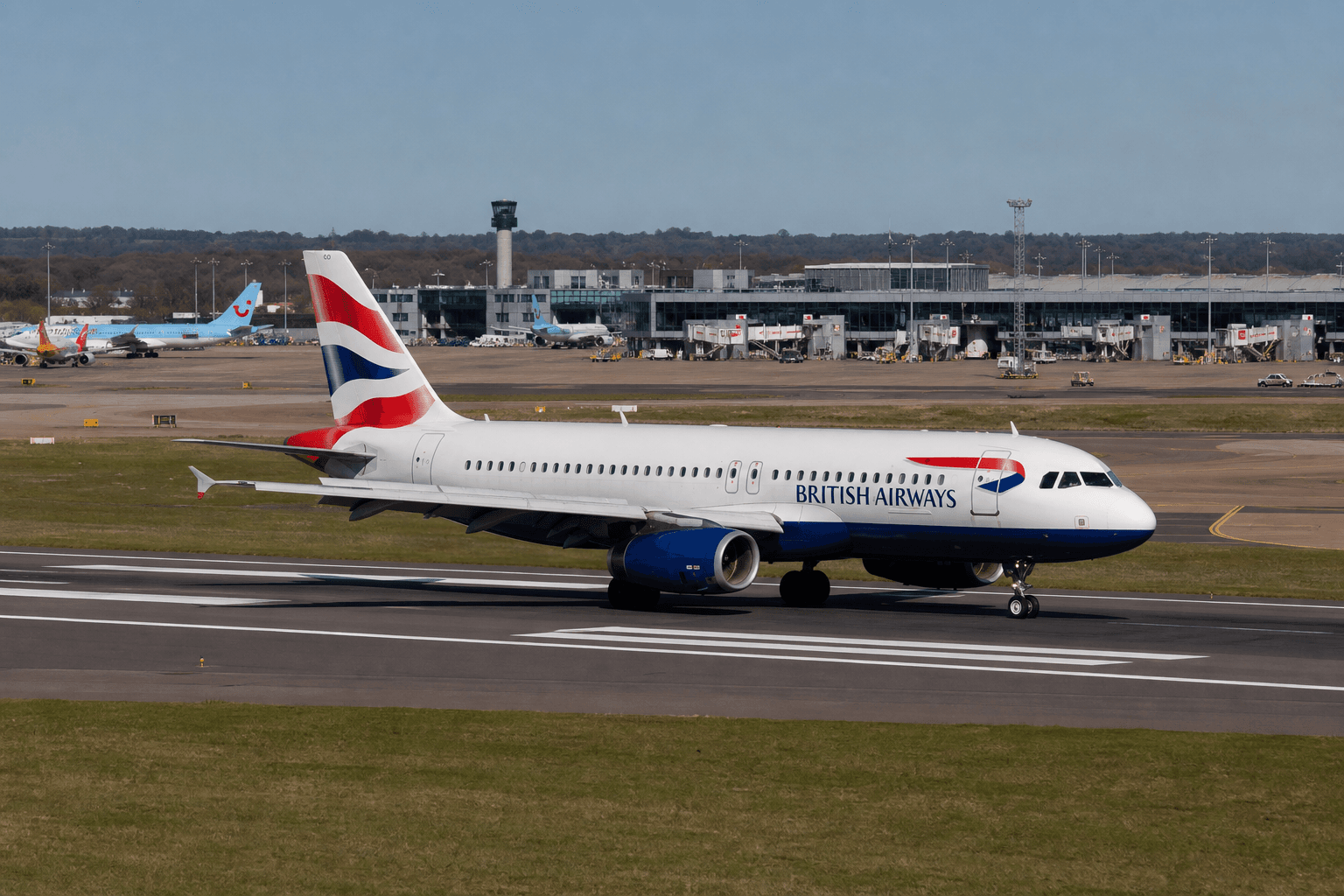Aerial view of London Gatwick Airport with a single runway busy with aircraft movements