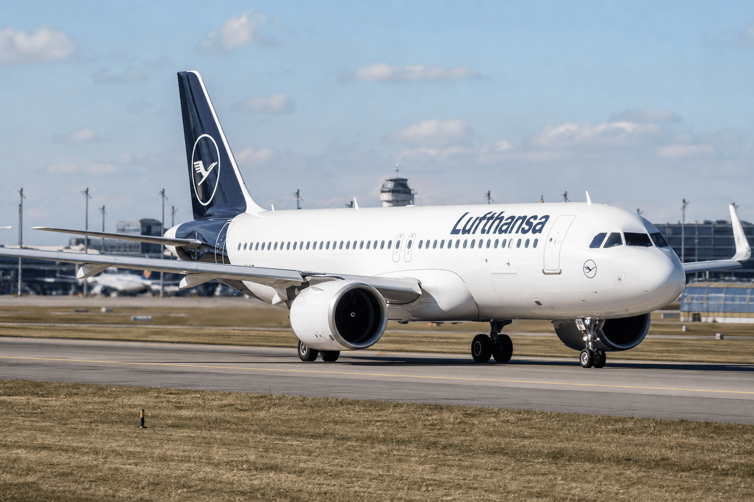 Airbus A320neo on runway preparing for departure with clear sky
