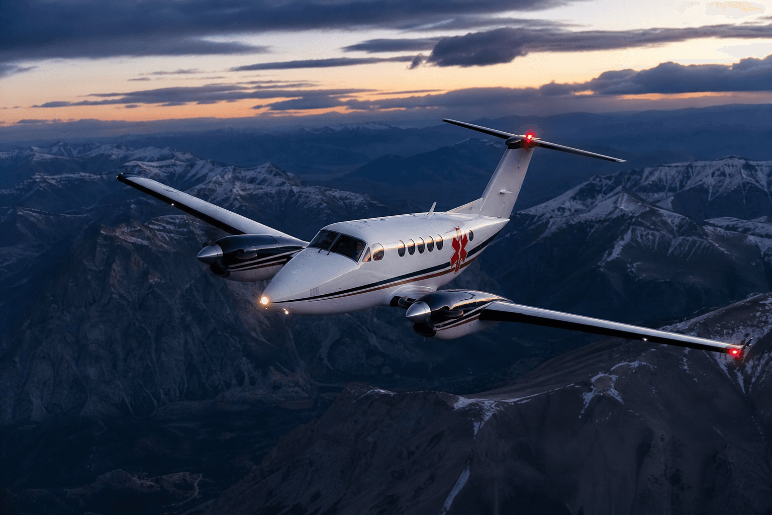 A Beechcraft King Air flying over rugged mountainous terrain at dusk