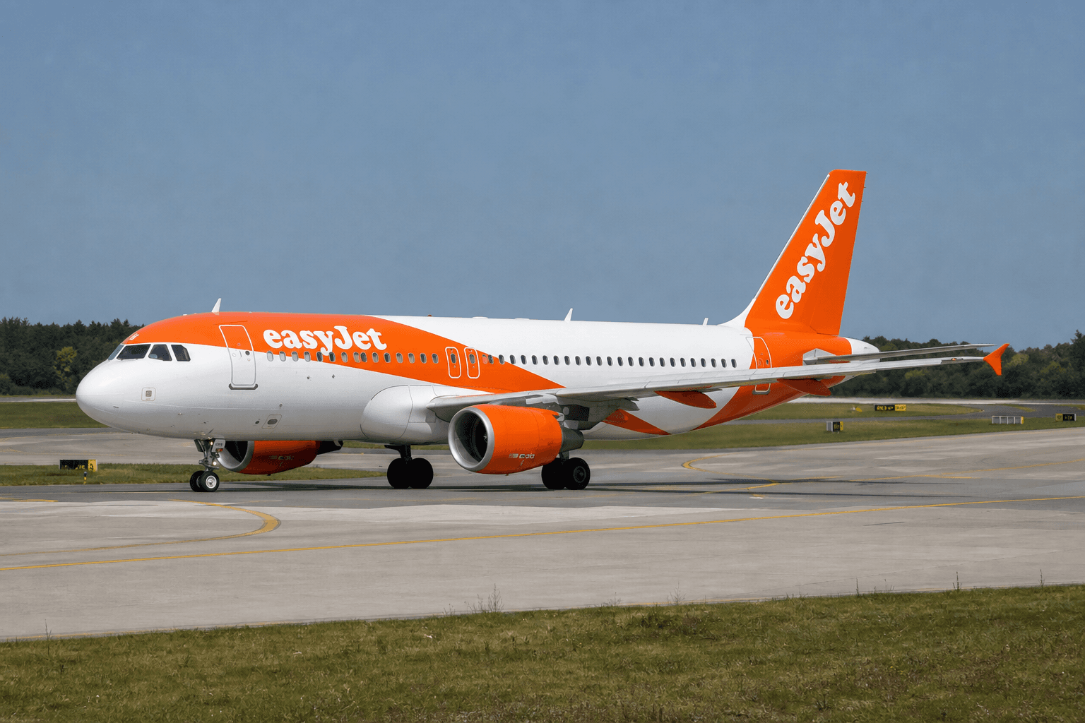 easyJet Airbus A320 taxiing at London Gatwick Airport on a bright day