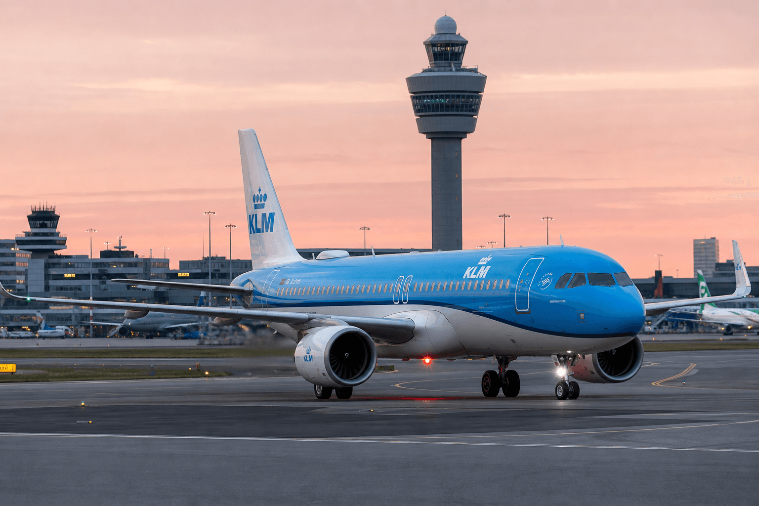 Airbus A320neo taxiing at Amsterdam Schiphol Airport amid evening light