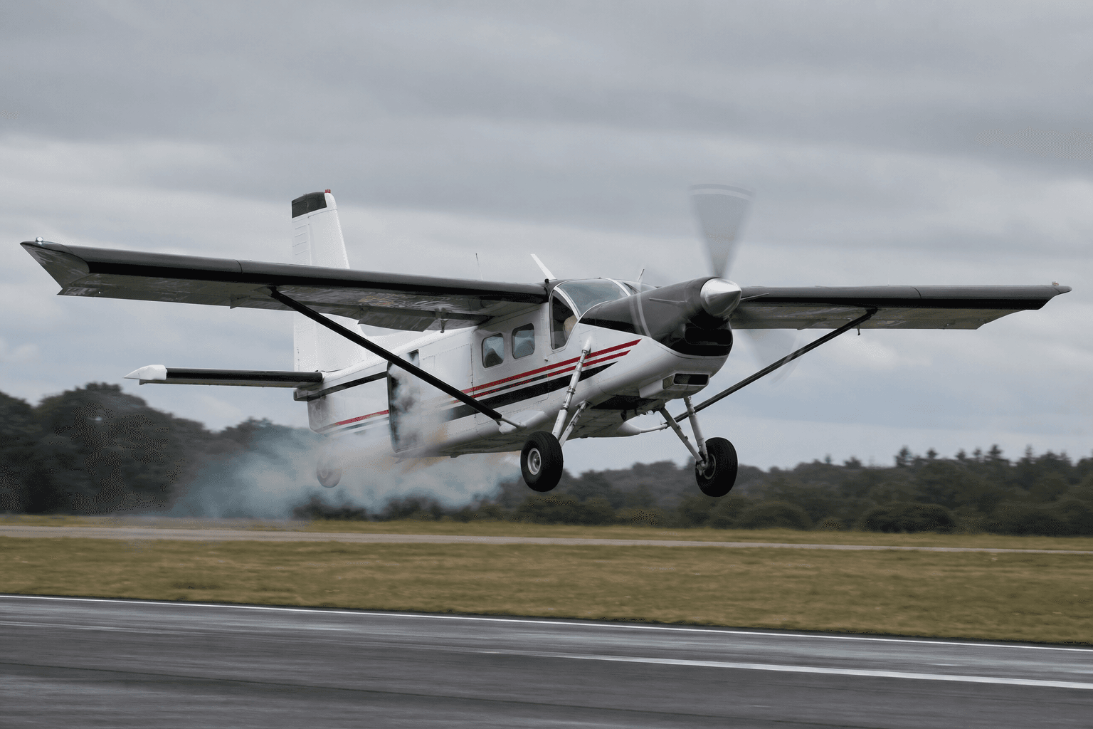Pilatus PC-6 aircraft during take-off with smoke near the cabin