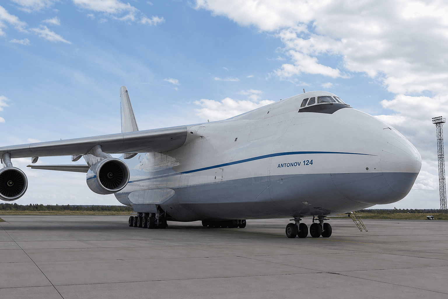 Antonov An-124 large military transport aircraft parked on an airfield apron during daytime