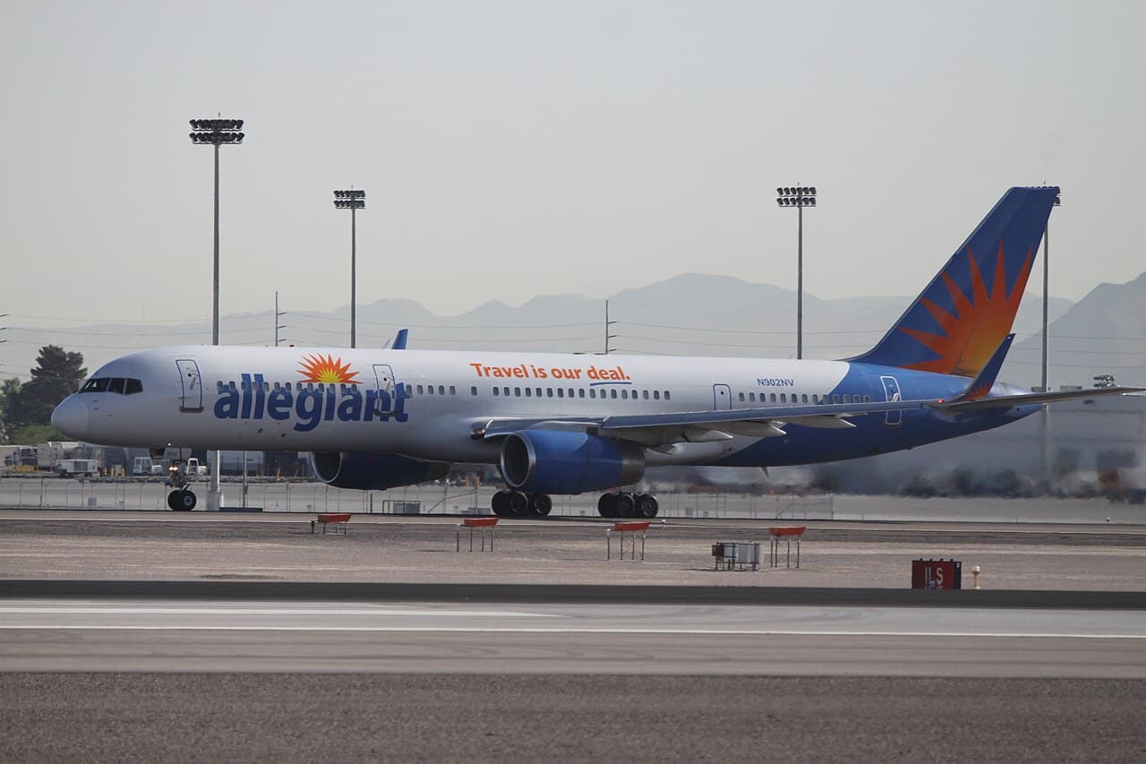 Allegiant Airlines aircraft taxiing at airport apron under clear sky
