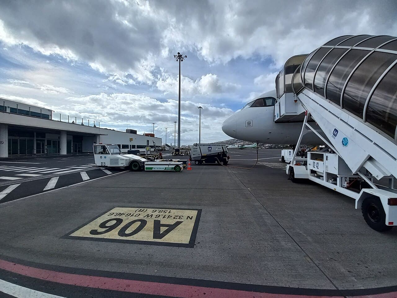 Regional turboprop aircraft landing at a small Indonesian airport on an outer island