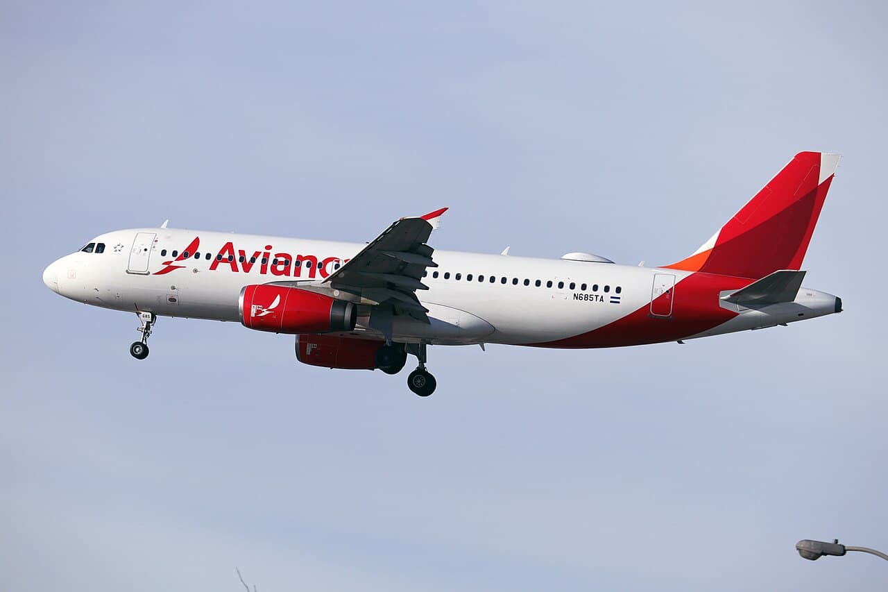Avianca aircraft preparing for departure at an international airport runway during daylight