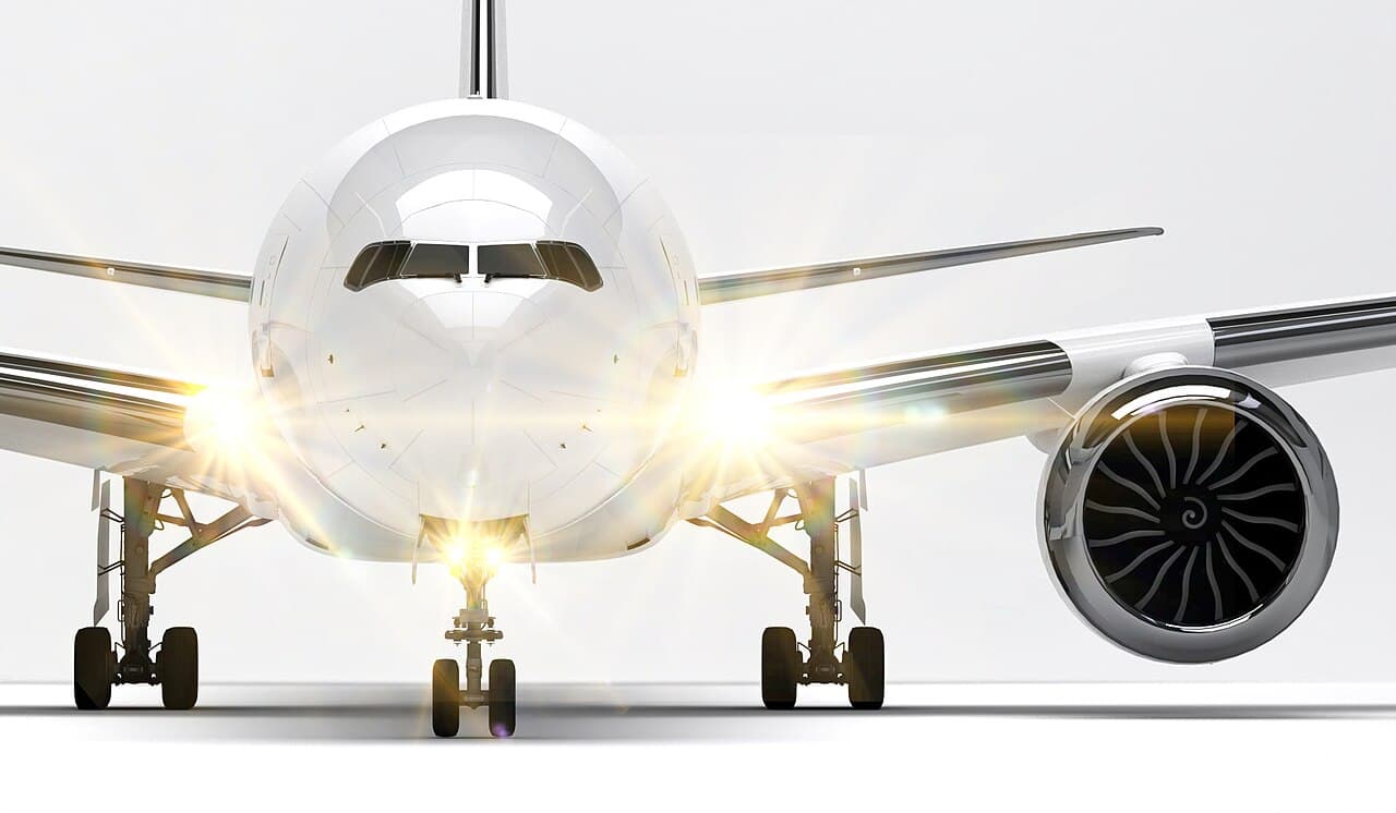 Boeing 777-9 in flight showcasing folding wingtips at sunset