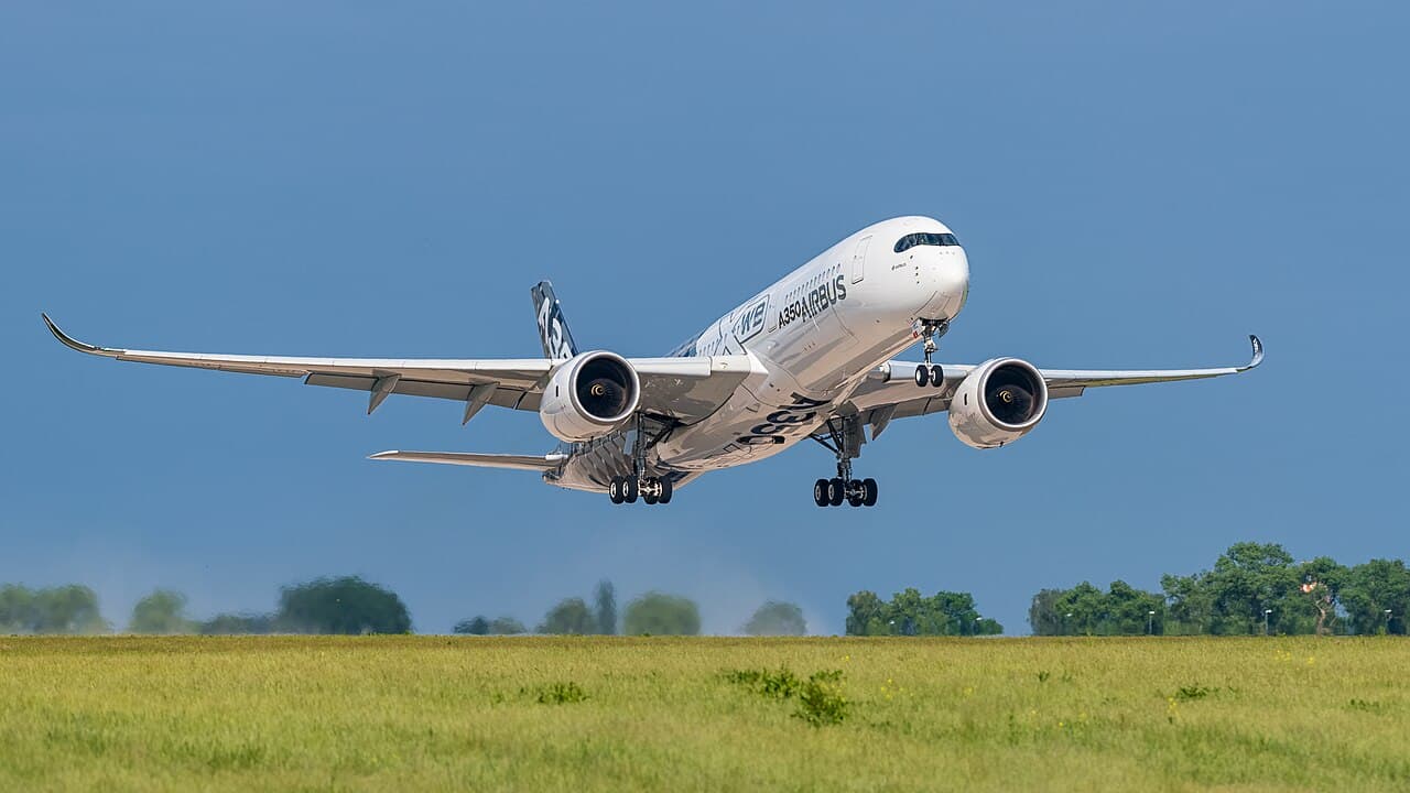 Airbus A350 aircraft interior showing premium business class cabin with lie-flat seats and spacious layout