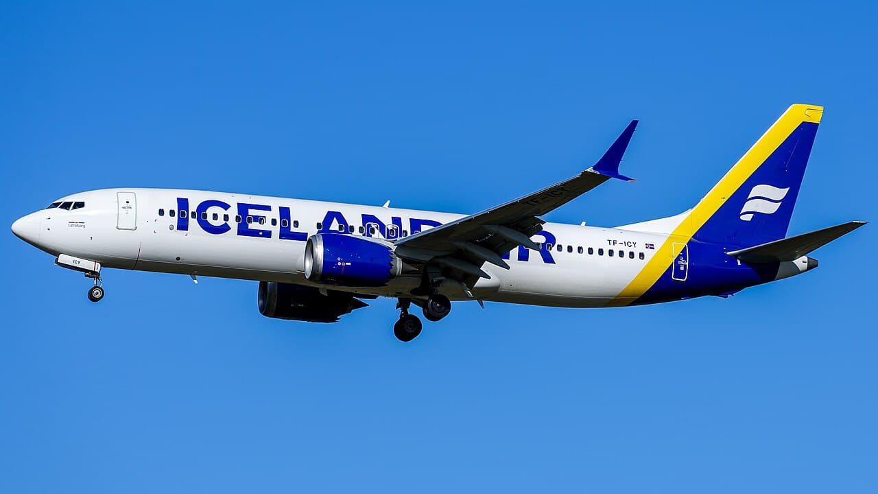 Boeing 737-8 aircraft taxiing at a modern international airport in Southeast Asia