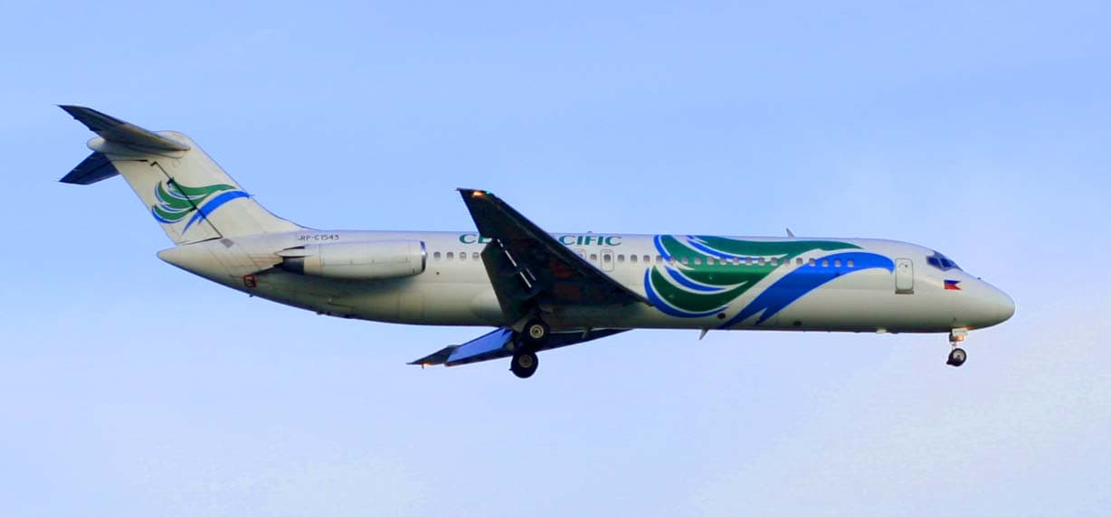 Cebu Pacific passenger aircraft taxiing on airport runway during daytime amid clear skies