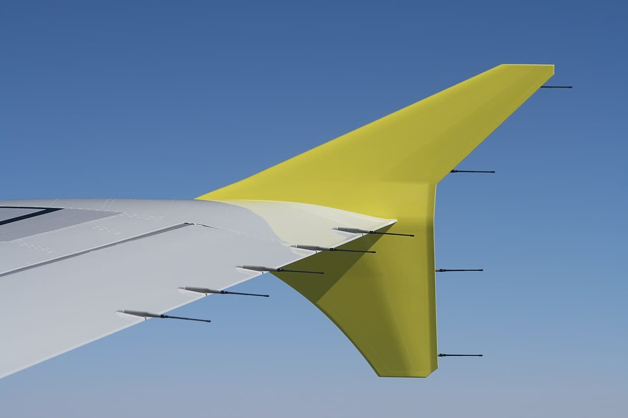 EasyJet Airbus A320 aircraft parked at a UK airport gate under overcast skies