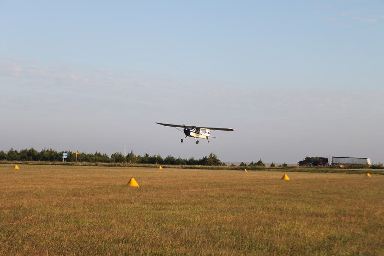 A single-engine piston aircraft parked on the ramp of a regional airport at sunset