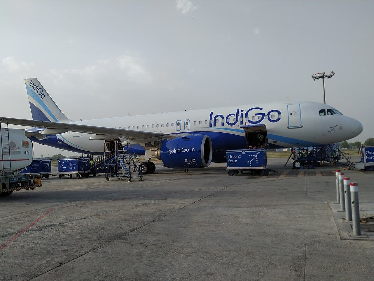 A Frontier Airlines aircraft equipped with satellite internet technology on airport tarmac.