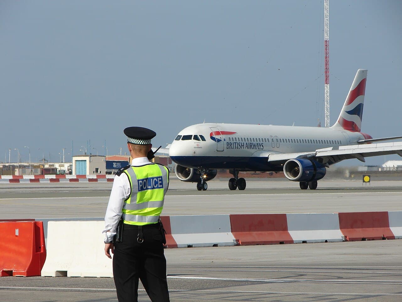 British Airways aircraft taxiing at airport under blue sky