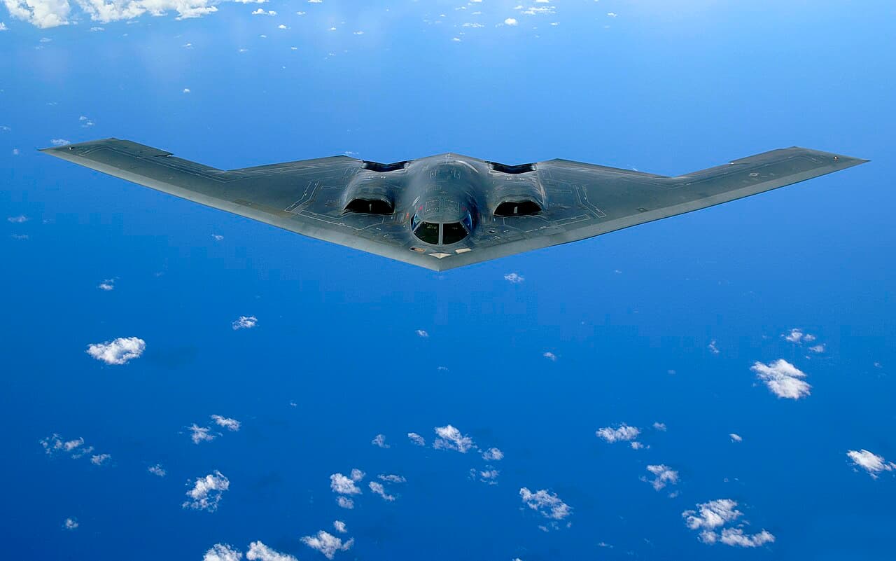 B-2 Spirit stealth bomber in flight against a blue sky