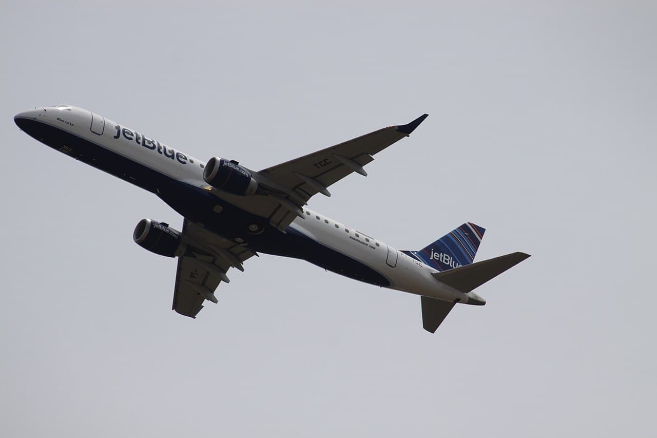 JetBlue aircraft taxiing at airport during daytime with updated cabin branding