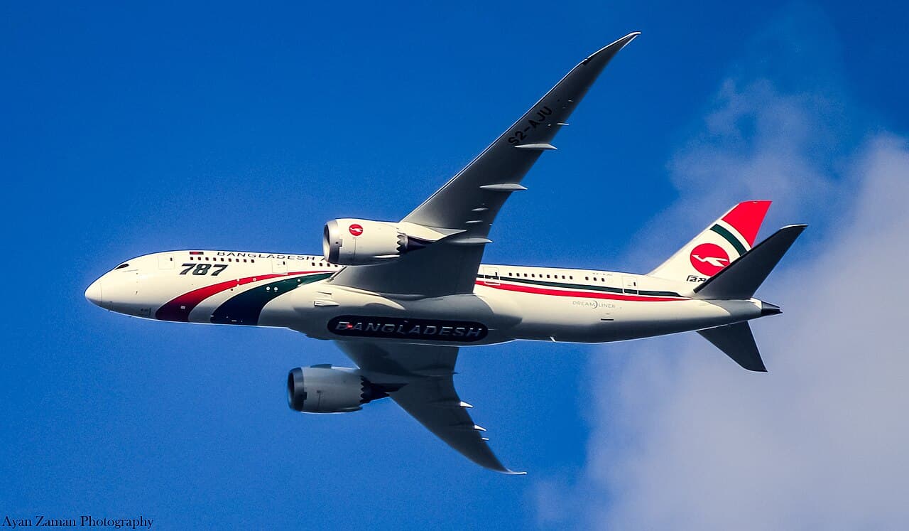 A Biman Bangladesh Airlines aircraft on the tarmac displaying the airline's iconic bird emblem on its tail.