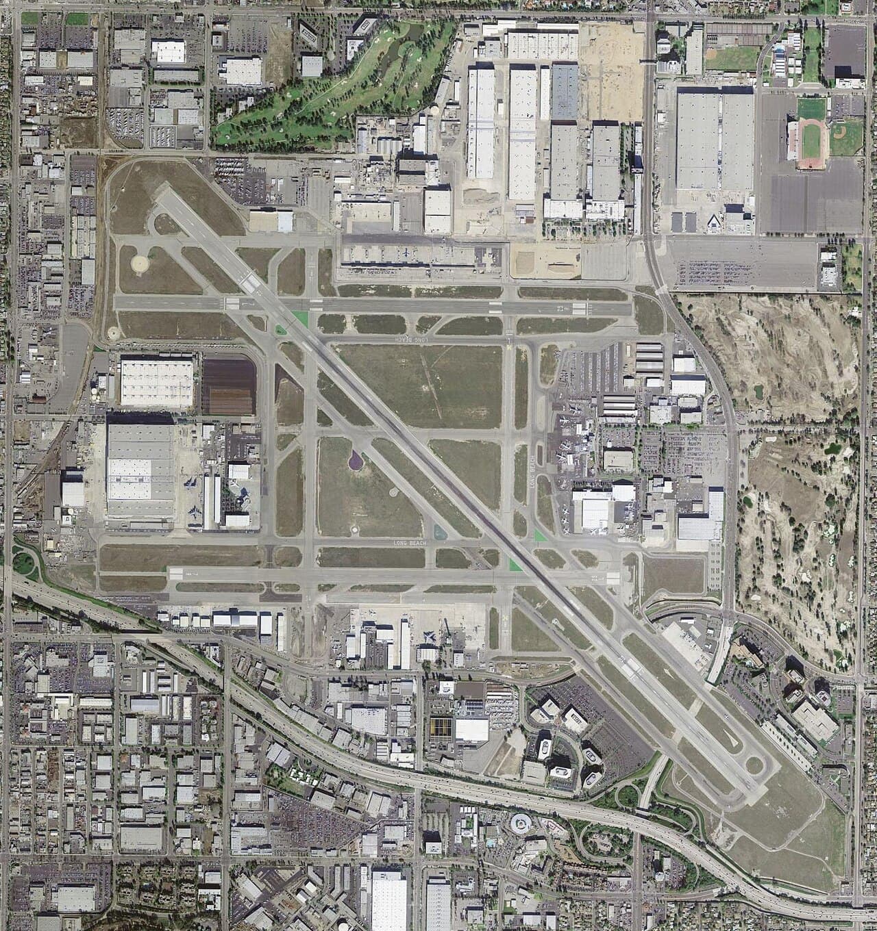 General aviation aircraft parked at Long Beach Airport ramp under clear sky