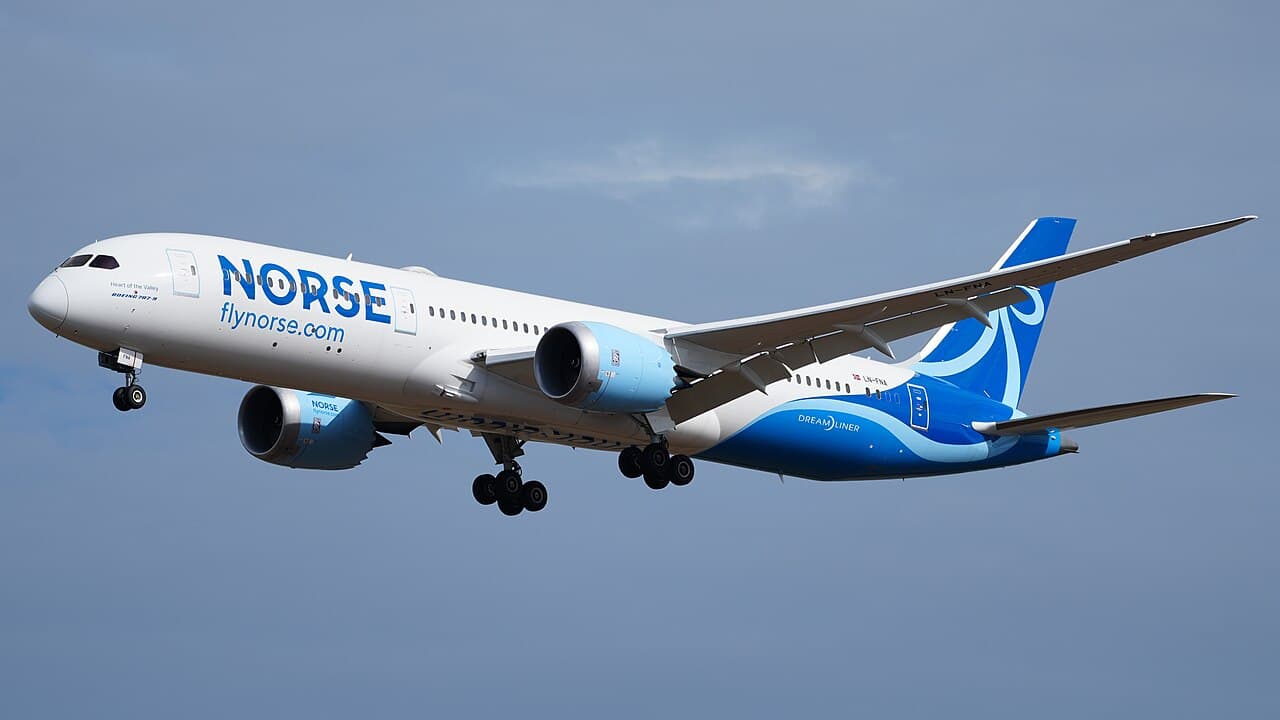 A Norse Atlantic Boeing 787 climbing after takeoff under bright daylight skies