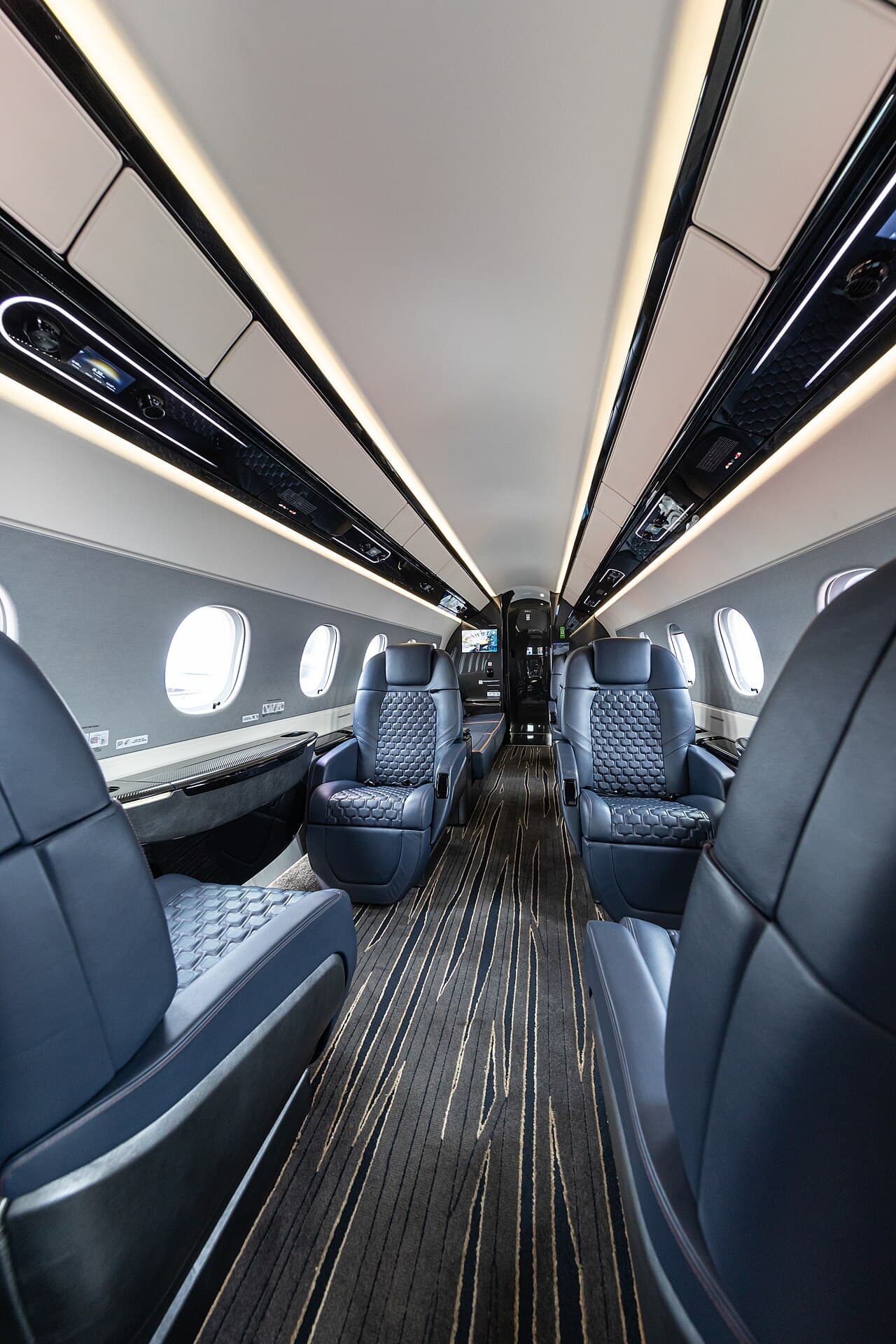 A midsize business jet parked on a sunlit airport ramp under a clear sky