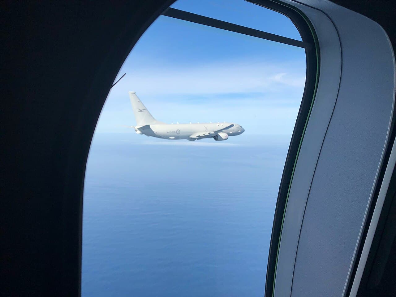 RAAF P-8A Poseidon maritime patrol aircraft flying over the ocean near Malaysia
