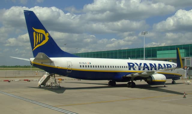 A Ryanair Boeing 737 taxiing on airport tarmac with cloud technology graphics overlay