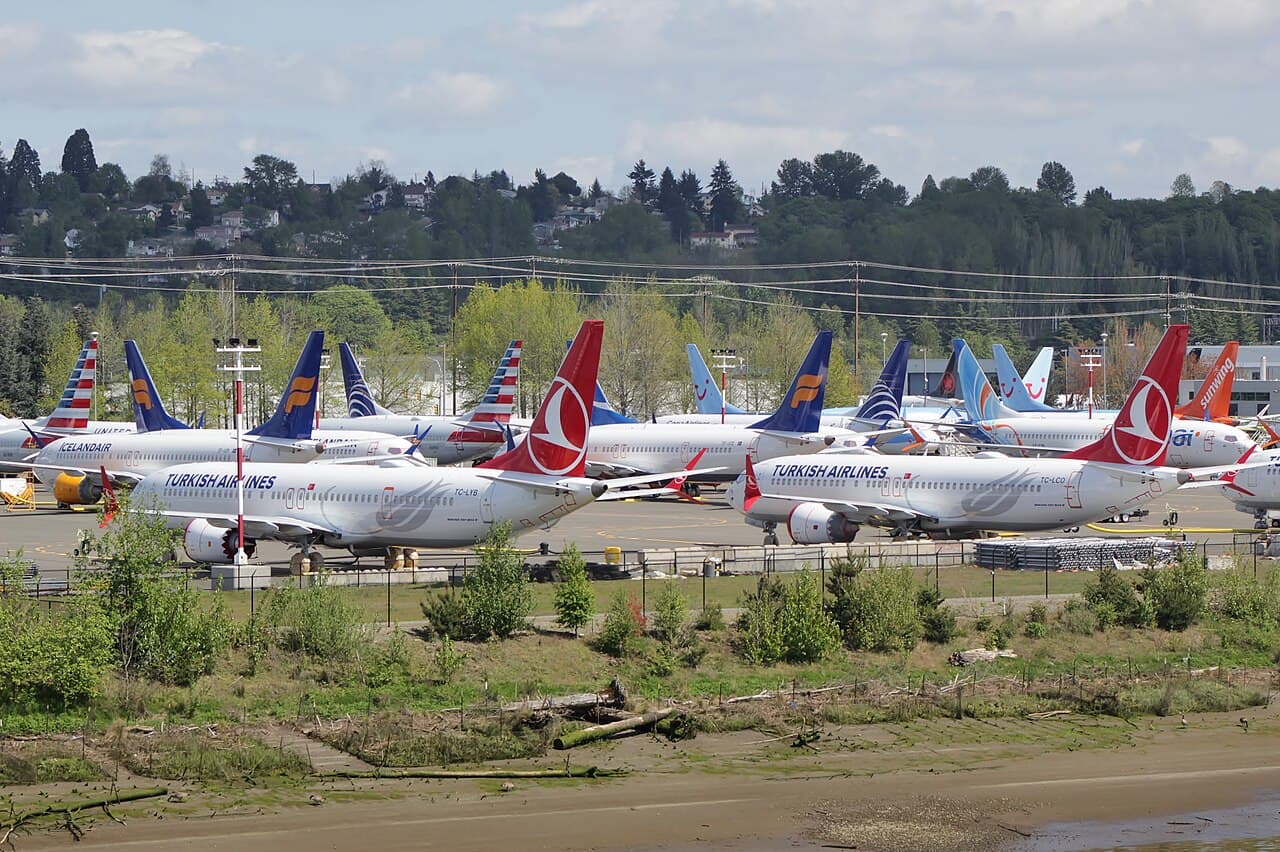 Boeing 737 MAX 8 on the ground at an airport with Somon Air livery under clear skies
