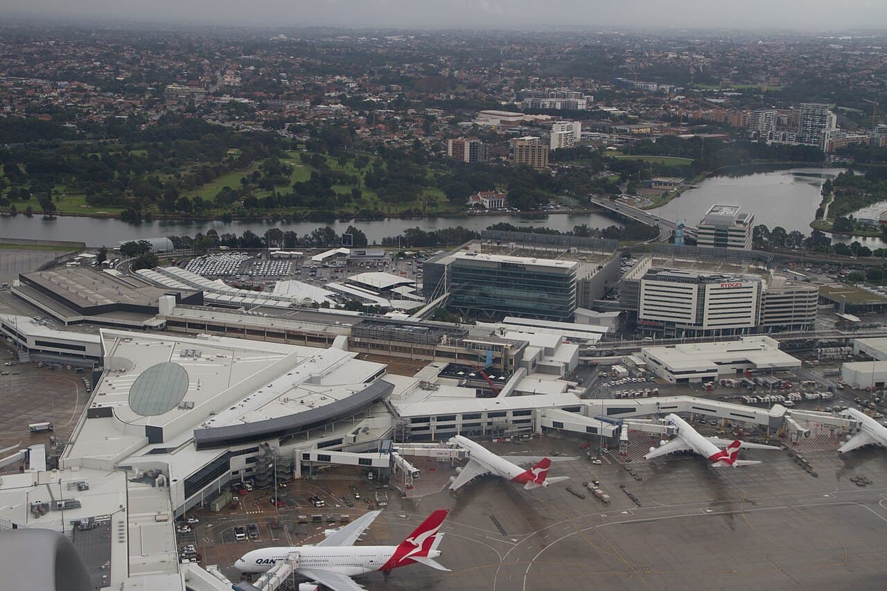 Sydney Airport terminal under redevelopment with aircraft taxiing nearby