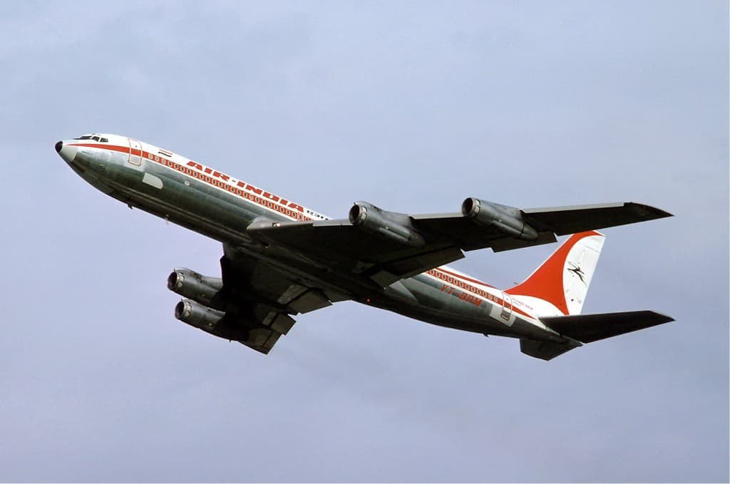 Douglas DC-8 freighter taxiing on airport ramp under clear sky