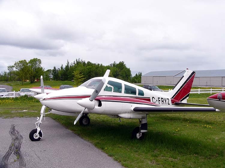 1960 Cessna 310D vintage twin aircraft parked on ramp with modern avionics visible in cockpit