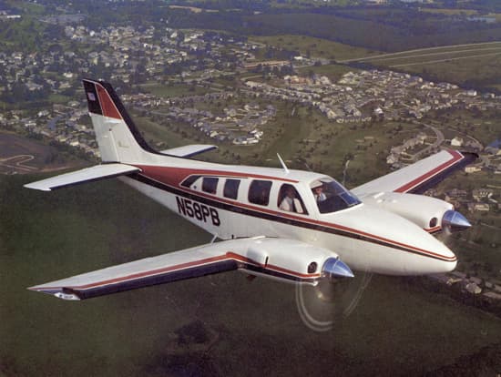 A 1979 Beechcraft Baron 58 taxiing on an airport ramp during daylight hours