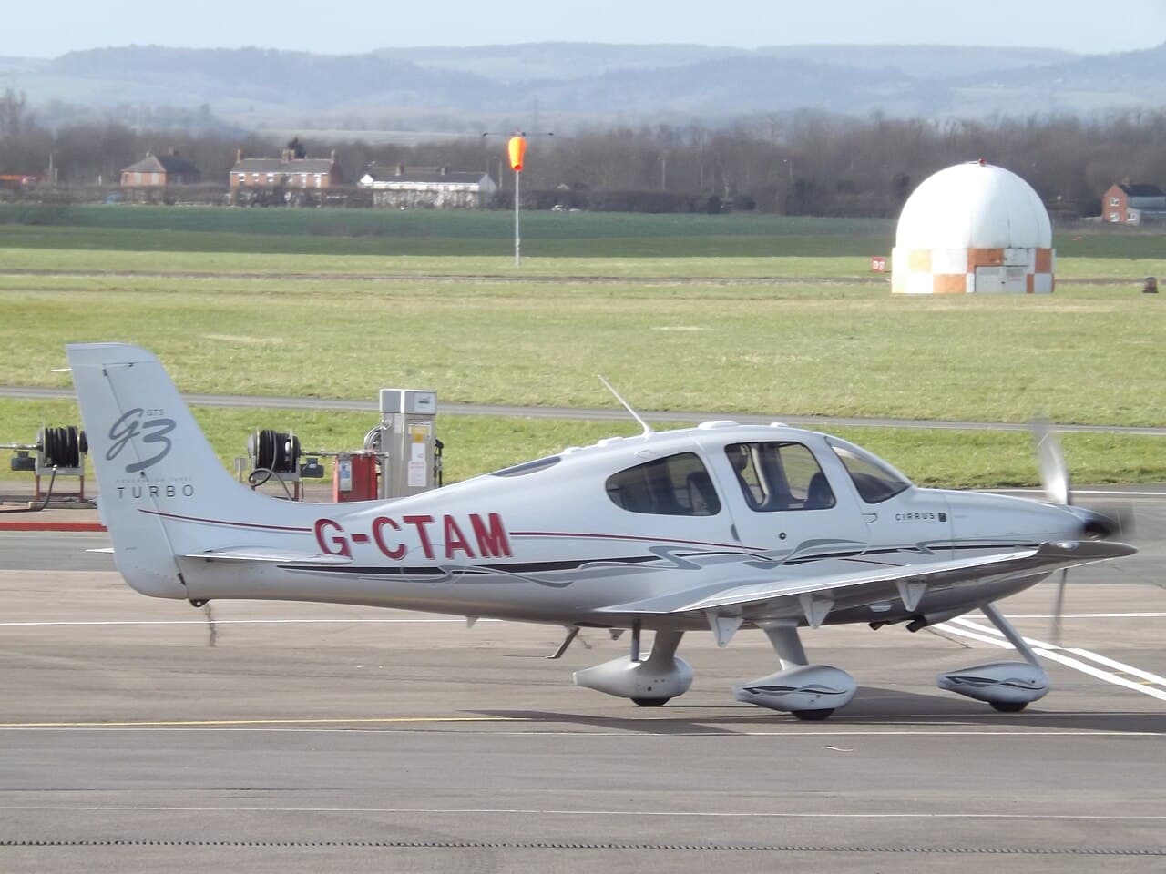 Cirrus SR22 G6 single-engine piston aircraft parked on airport ramp with blue-and-silver paint