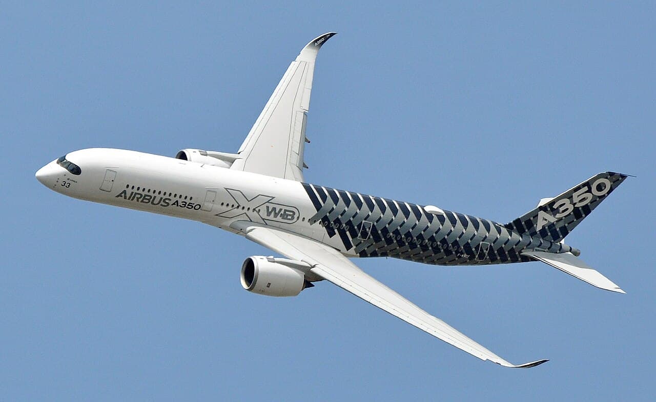 Airbus A350-900 taxiing at Munich Airport with bright sky overhead